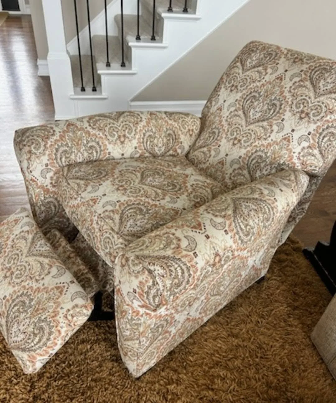 Upholstered chair with patterned fabric and matching ottoman detail by Creative Stitches Workroom in Grand Blanc, MI.